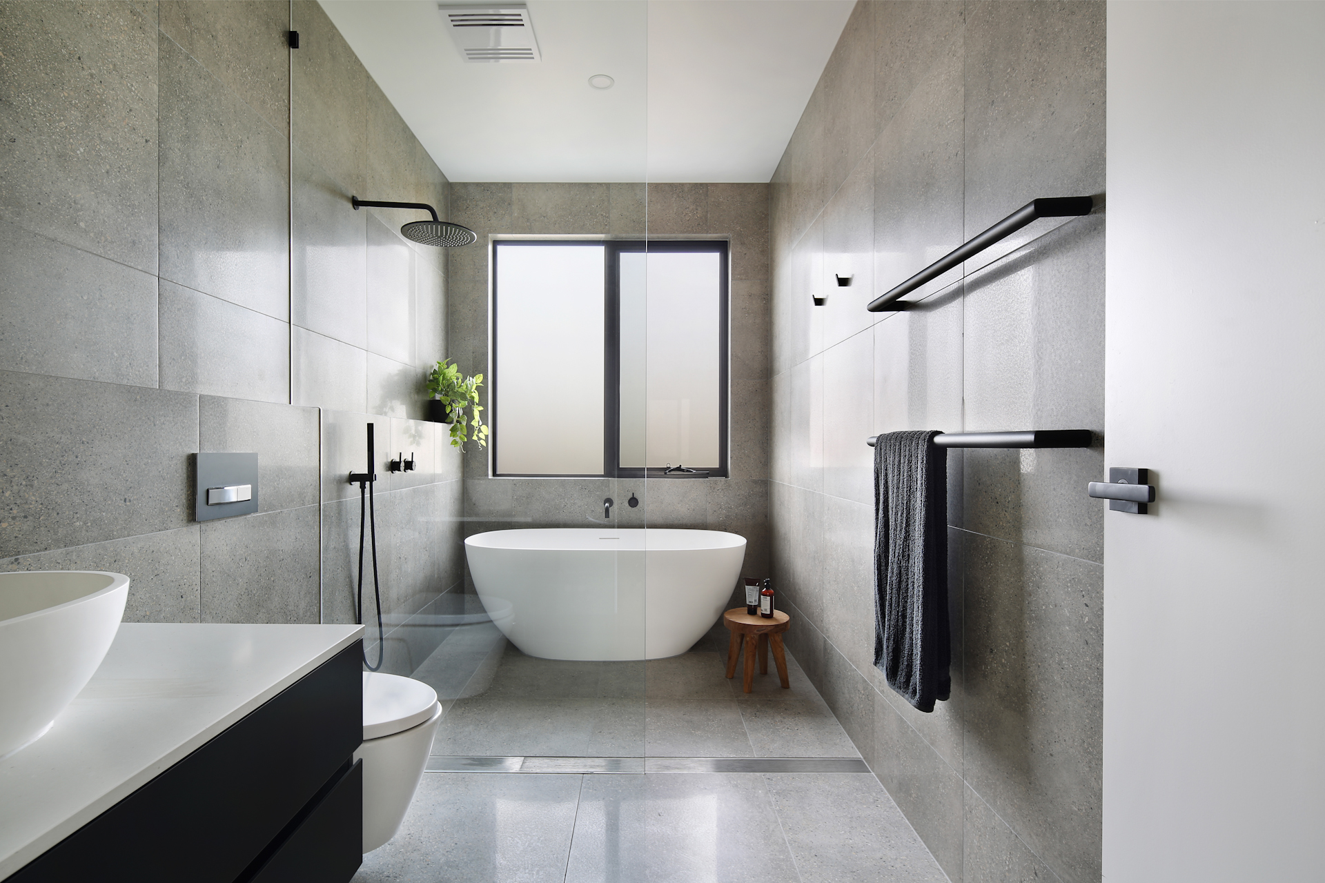 modern tiled bathroom with rainshower and boutique bathtub